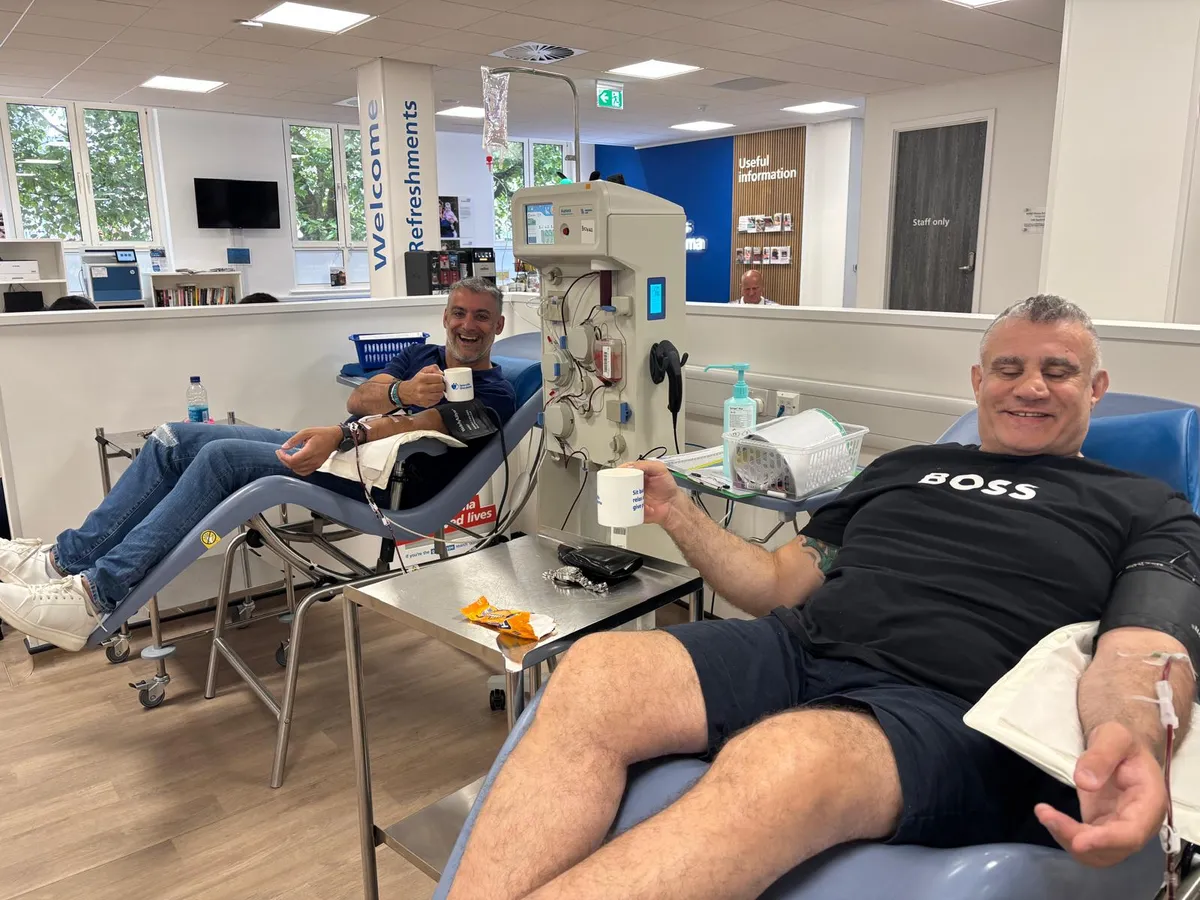 Paul Cadman donating plasma with his friend Phil Upton
